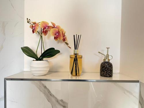 three vases sitting on a shelf with flowers at Bedroom Dordrecht Centrum - La Focaccina in Dordrecht