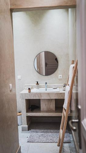a bathroom with a sink and a mirror at Luxury villa in Azib Oulad Lâdem