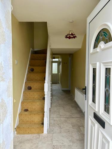 a hallway with stairs in a house at An Teach Ban in Tralee
