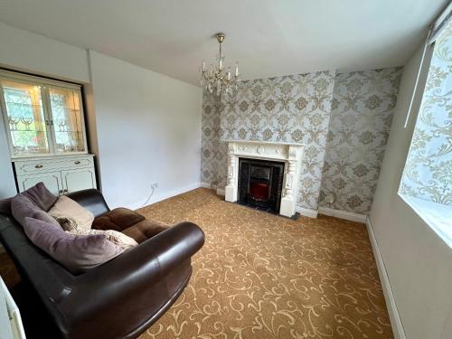 a living room with a couch and a fireplace at An Teach Ban in Tralee