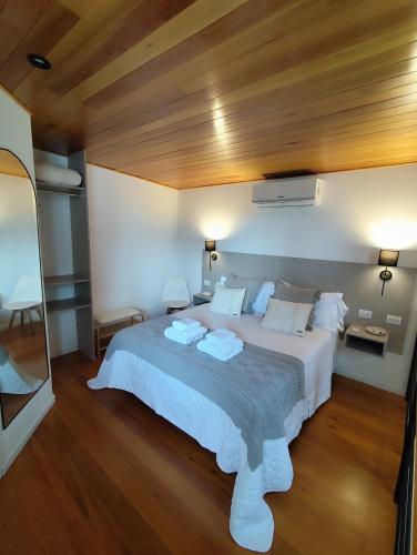 a bedroom with a large bed with a wooden ceiling at Rincon de Luna, Cabañas in Mar del Plata