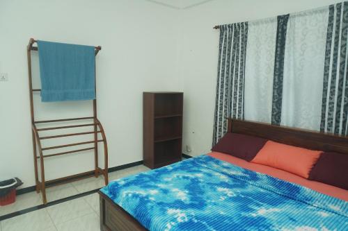 a bedroom with a bed and a ladder in it at T-Nova Guest House in Trincomalee