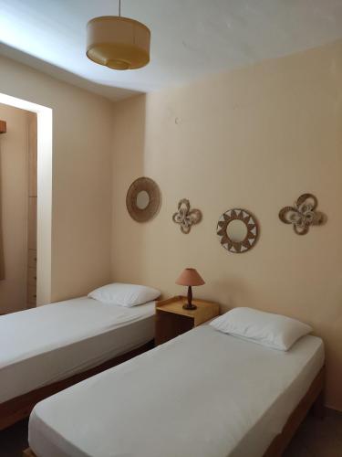 a bedroom with two beds and a lamp on a table at Seaside villa in Eretria in Eretria