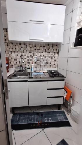 a small kitchen with a sink and a stove at Minicasa Show! in Jandira