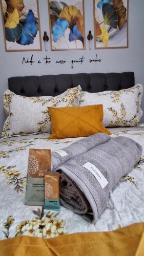 a bed with some blankets and pillows on it at Minicasa Show! in Jandira