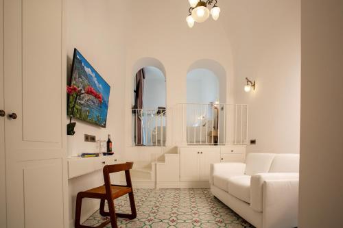 a living room with a white couch and a chair at Hotel Marina Riviera in Amalfi