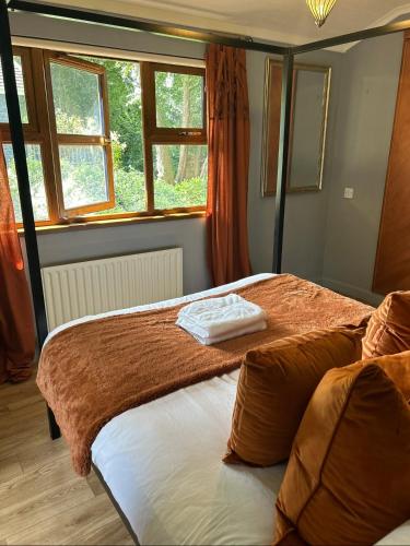 a bedroom with two beds and a window at Woodside Lodge, Weybourne, Holt in Weybourne