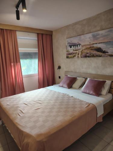 a bedroom with a large bed with red curtains at Jelena Lapčići Budva in Budva