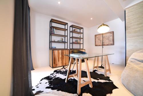 a room with a desk and a bed at The Boat Shed by The Oyster Collection in Kenton on Sea