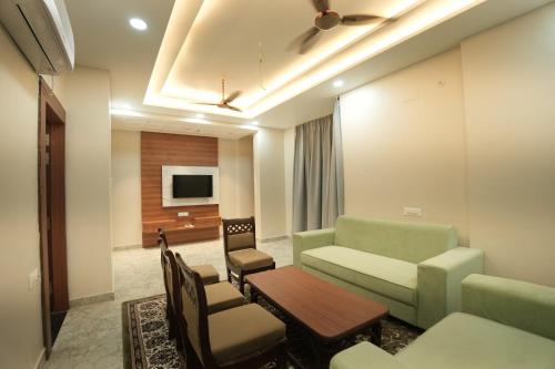 a living room with a couch and a table at Hotel Chanda in Jhānsi