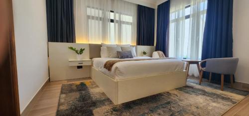 a bedroom with a large bed and a table and chairs at Anona Beachfront Villa in Filadu