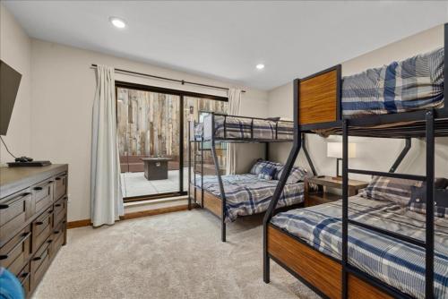 a bedroom with two bunk beds and a dresser at Hauser House Unit 1 Dog Friendly in Red Lodge