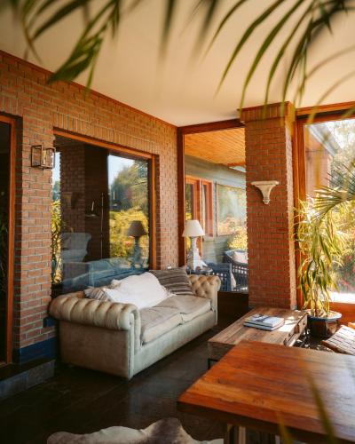 a living room with a bed in a brick wall at Casa Molino Hotel Boutique & Restaurant Puerto Varas in Puerto Varas