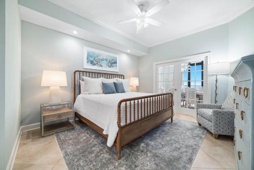 a bedroom with a bed and a chair at The Oasis 805 in Orange Beach