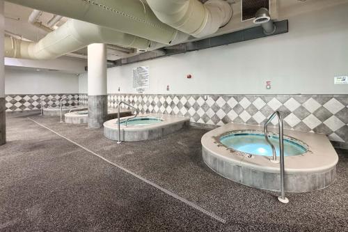 a bathroom with three jacuzzi tubs in a building at The Oasis 805 in Orange Beach