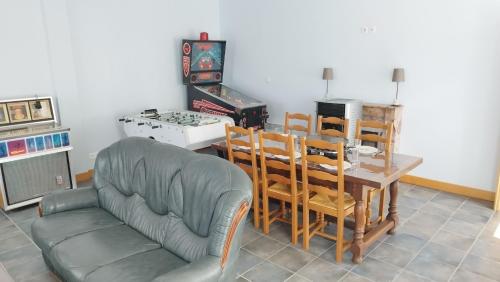 a living room with a table and chairs and a couch at Le Balcon de la Pierre Claire in Villersexel