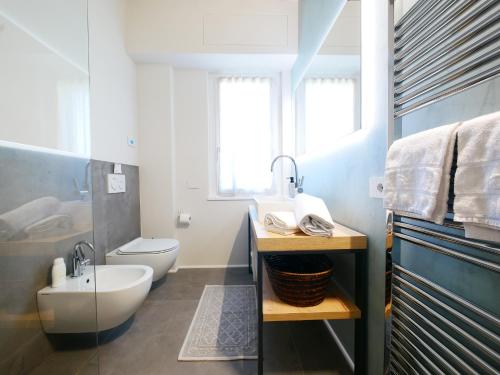 a bathroom with a sink and a toilet at Restorative stay Garden Jacuzzi Lake View in Lierna