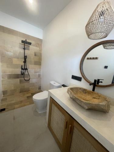 a bathroom with a sink and a toilet at Villa Rosa Dreams 2 in Ungasan