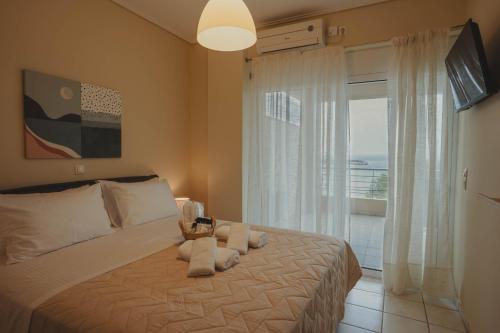 a bedroom with a bed with a large window at Almy Sea Apartment in Karistos
