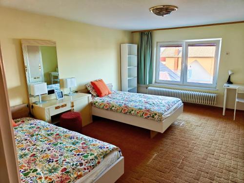 a hotel room with two beds and a window at Angela Hostel in Fram