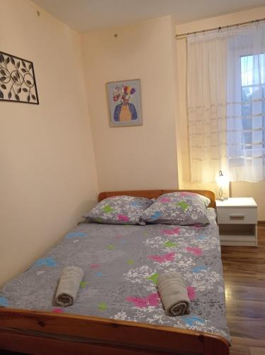a bedroom with a bed with two pillows on it at POLANA in Leśna