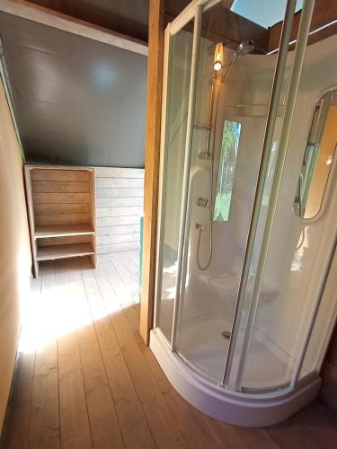 a shower with a glass door in a bathroom at Resort Orizzonti Glamping in SantʼElpidio a Mare