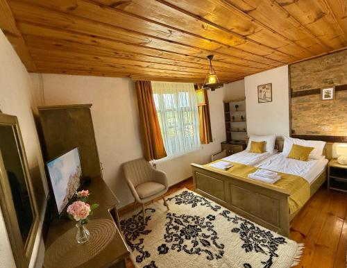 a bedroom with a bed and a wooden ceiling at ART Guest Home in Leshten