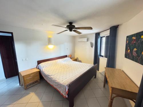 a bedroom with a bed and a ceiling fan at Casa Caracol Los Farallones in Cabrera