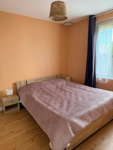a bedroom with a bed and a window at Maison 2 chambres avec jardin et parking privatif in Saran