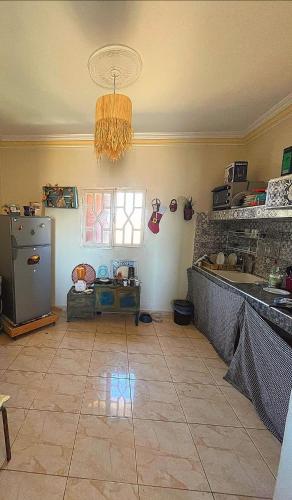 a kitchen with a refrigerator and a window at Villa Rabia in Sidi Kaouki