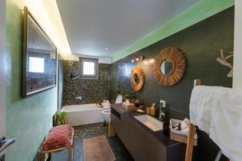 a bathroom with a sink and a toilet and a tub at Villa Cycladic View Syros in Azolimnos Syros