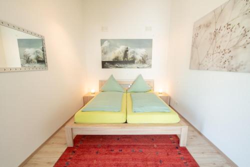 a bed in a room with a red rug at Am Bienenfeld in Ettenheim