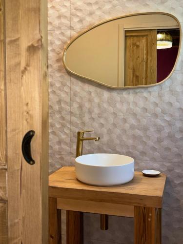 a bathroom with a sink and a mirror at Hôtel Aghjola in Pioggiola