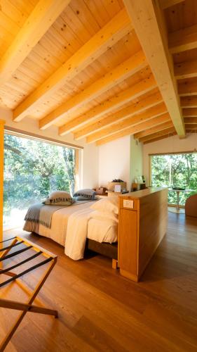 a bedroom with a large bed and a large window at Le Case Resort in Macerata