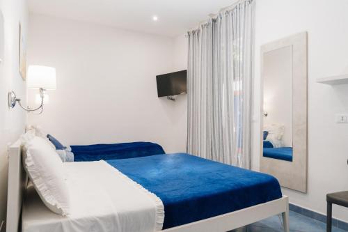 a bedroom with a bed and a mirror at Relais Villa Ettore in Barano d'Ischia
