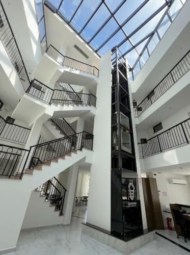 a lobby with stairs and a glass ceiling at The Honeycomb Boutique Hotel in Golem