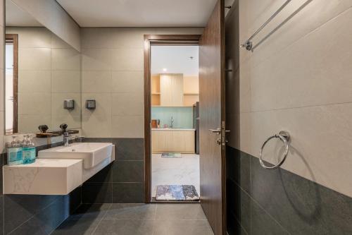 a bathroom with a sink and a shower at Lucent Home in Gò Công