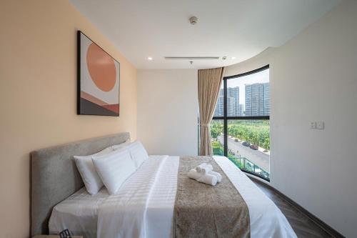 a bedroom with a bed with a stuffed animal on it at Lucent Home in Gò Công