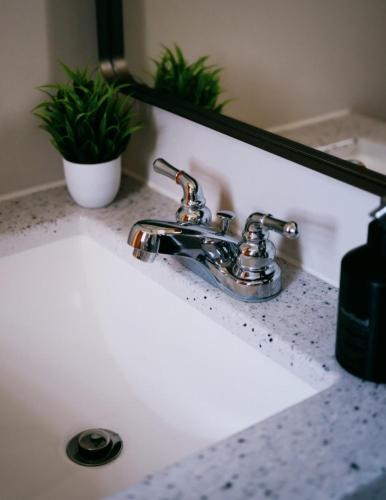 a bathroom sink with a faucet and a mirror at 3BR Modern Apt • Gym • Workspace • Quiet Location in Chicago