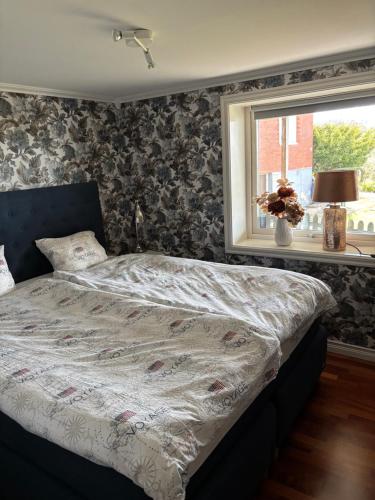 a bed sitting in a bedroom with a window at Casa utsikten in Uddevalla