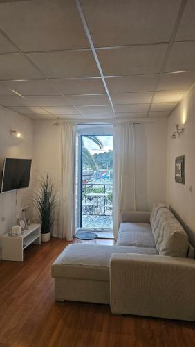 a bedroom with a large bed and a large window at Apartment Adriatica City in Makarska