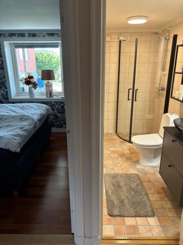 a bathroom with a bed and a shower and a toilet at Casa utsikten in Uddevalla