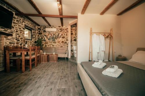 a bedroom with a bed and a dining room with a table at Ellafos Traditional Living-Elafonisi Couples Retreat in Elafonisi