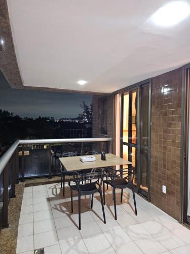 a patio with a table and chairs on a balcony at Flat na praia da Barra 2 in Rio de Janeiro