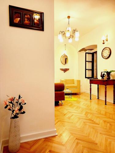 a living room with a vase with flowers in it at Cozy Central Nest Kotor in Kotor