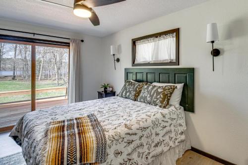 a bedroom with a bed and a large window at Long Lake Cabin w/ Dock: Fish & Hike! in Walker