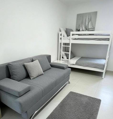 a living room with a couch and a bunk bed at My Miracle Stinica in Stinica