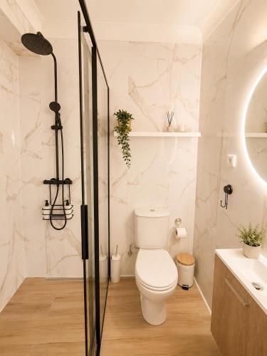 a bathroom with a toilet and a glass shower at Casa Concha - Peaceful and Relaxing in Lagos