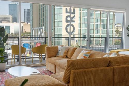a living room with a couch and a large window at Million Dollar Fireworks View no 412 in Dallas