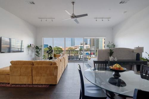 a living room with a couch and a glass table at Million Dollar Fireworks View no 412 in Dallas